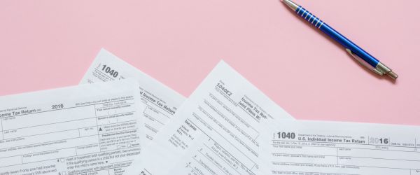 Tax papers on a pink background