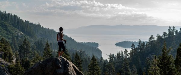 Woman hiking overlooking a lake